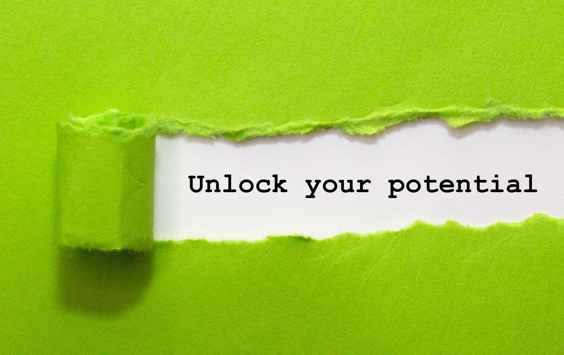 Unlock Your Potential Written Under Green Torn Paper